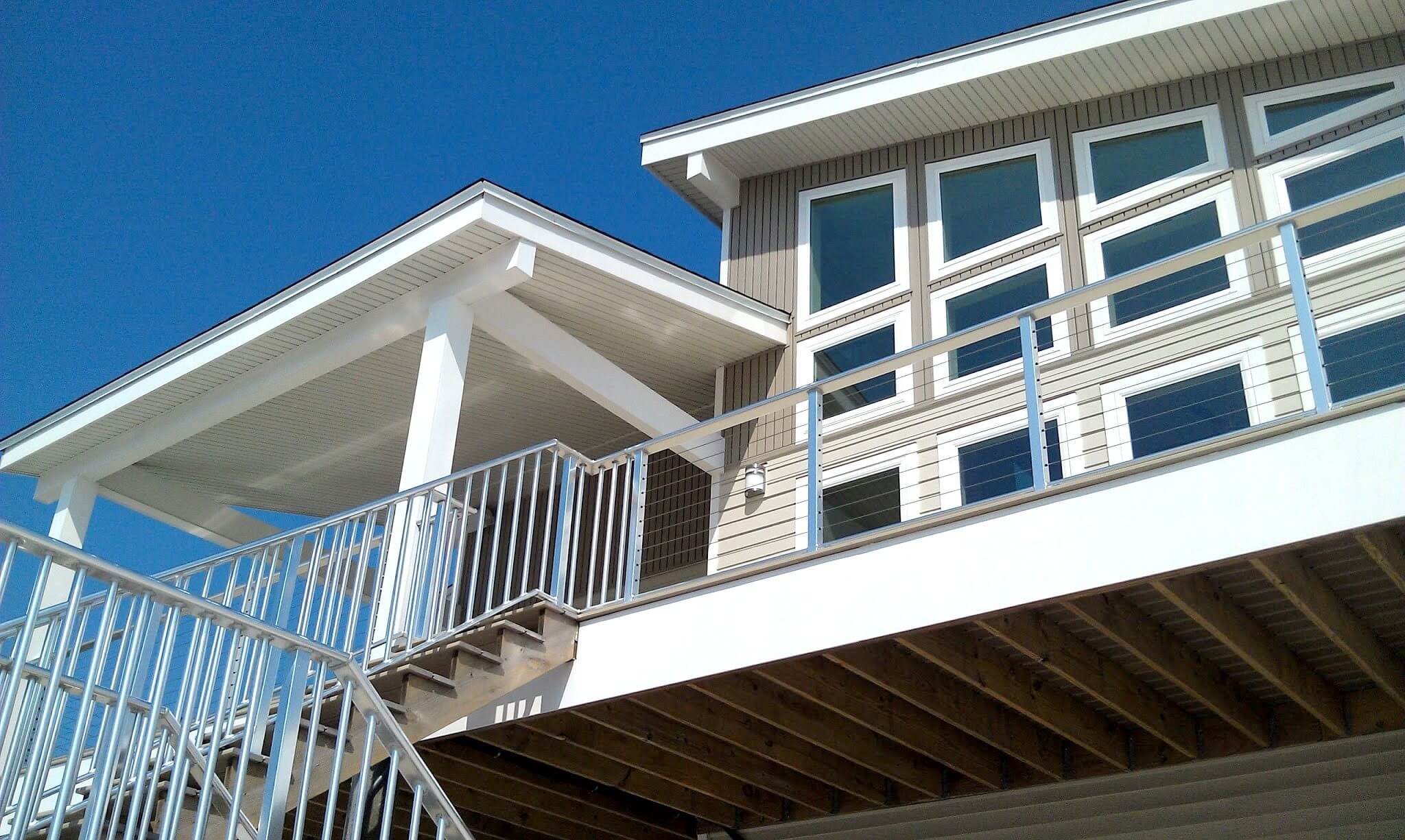Grand Lagoon New Construction wrap around porch and railings by Highpointe DBR, LLC