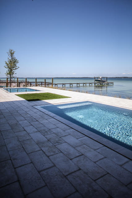 Double pools with a water view by Highpointe DBR, LLC