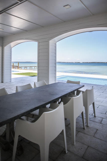 Outdoor entertaining area on the water by Highpointe DBR, LLC