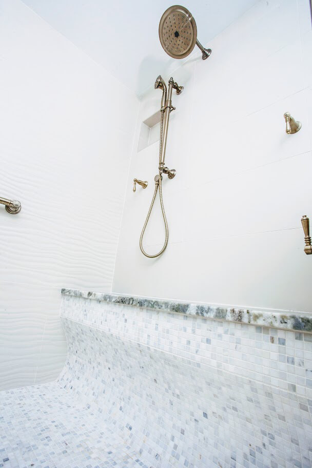 Tiled shower in Eden Condominium by Highpointe DBR, LLC