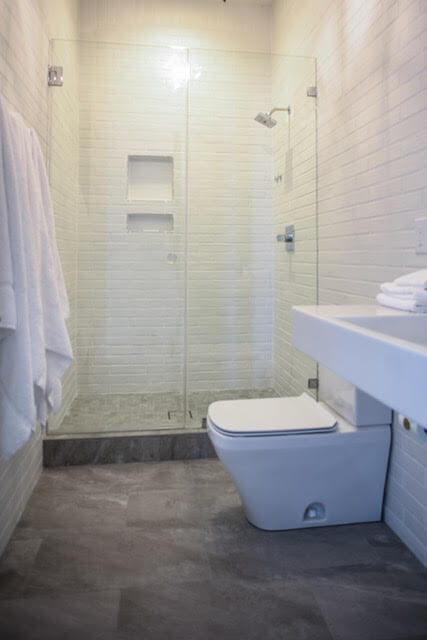 Bathroom with glass shower enclosure in custom home by Highpointe DBR, LLC